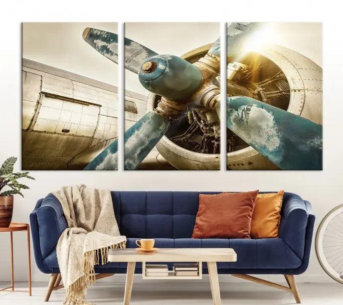 The Vintage Airplane Canvas Print, featuring a triptych design with an airplane propeller on museum-quality canvases with UV-protective coating, is displayed in a cozy living room.