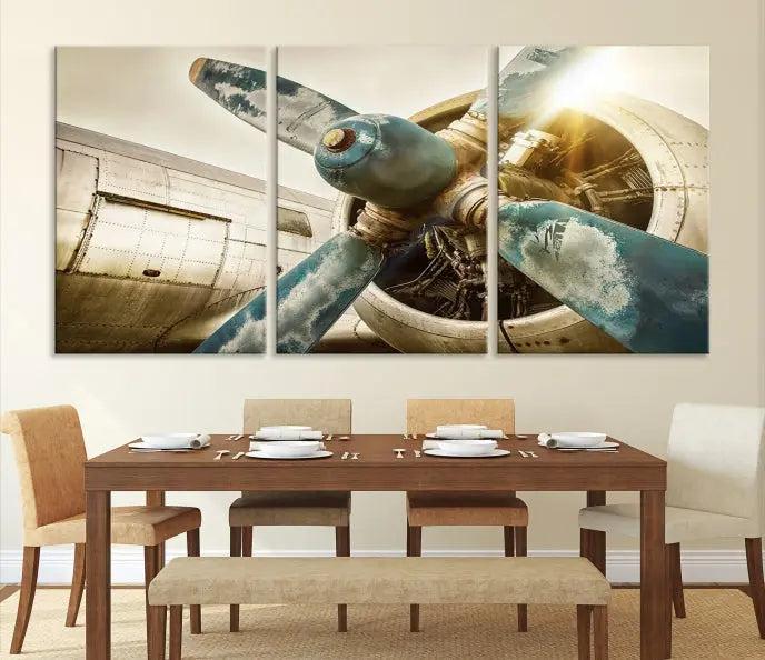 The Vintage Airplane Canvas Print, featuring a triptych design with an airplane propeller on museum-quality canvases with UV-protective coating, is displayed in a cozy living room.