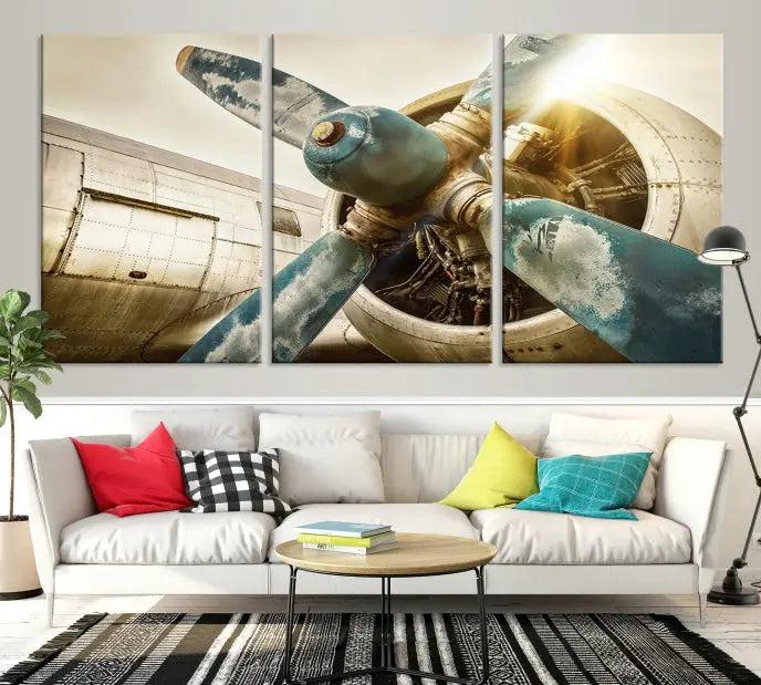 The Vintage Airplane Canvas Print, featuring a triptych design with an airplane propeller on museum-quality canvases with UV-protective coating, is displayed in a cozy living room.