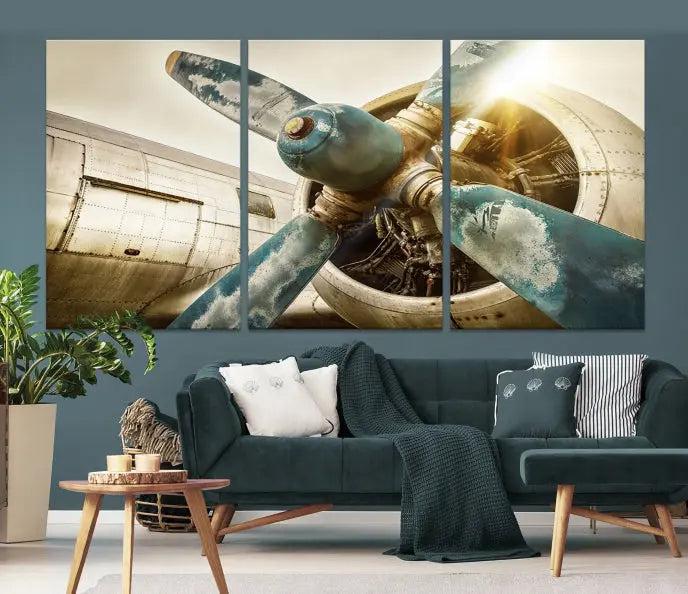 The Vintage Airplane Canvas Print, featuring a triptych design with an airplane propeller on museum-quality canvases with UV-protective coating, is displayed in a cozy living room.