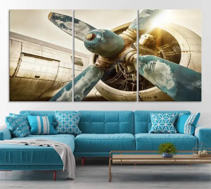 The Vintage Airplane Canvas Print, featuring a triptych design with an airplane propeller on museum-quality canvases with UV-protective coating, is displayed in a cozy living room.