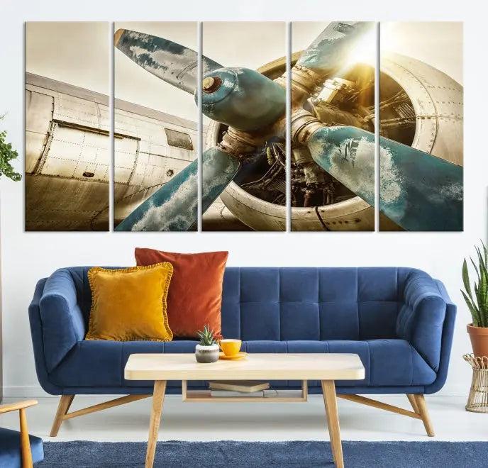 The Vintage Airplane Canvas Print, featuring a triptych design with an airplane propeller on museum-quality canvases with UV-protective coating, is displayed in a cozy living room.