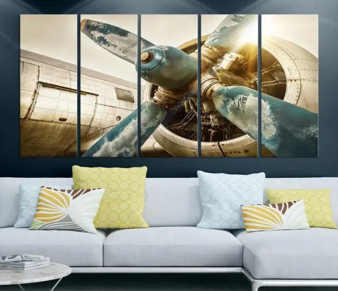 The Vintage Airplane Canvas Print, featuring a triptych design with an airplane propeller on museum-quality canvases with UV-protective coating, is displayed in a cozy living room.