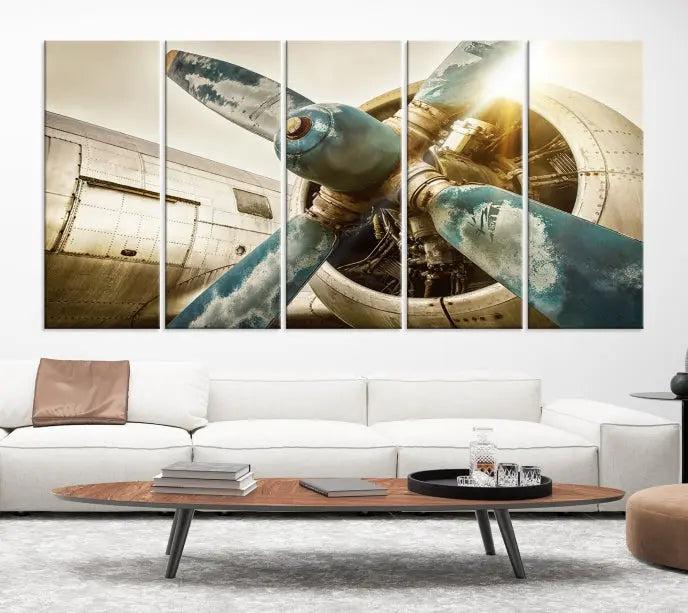 The Vintage Airplane Canvas Print, featuring a triptych design with an airplane propeller on museum-quality canvases with UV-protective coating, is displayed in a cozy living room.