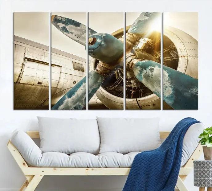 The Vintage Airplane Canvas Print, featuring a triptych design with an airplane propeller on museum-quality canvases with UV-protective coating, is displayed in a cozy living room.