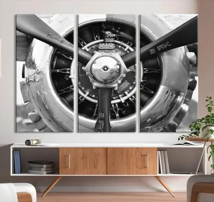 The Vintage Airplane Wall Art Canvas Print features a black and white image of an aircraft engine propeller elegantly divided into three panels.