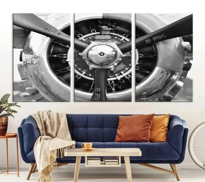 The Vintage Airplane Wall Art Canvas Print features a black and white image of an aircraft engine propeller elegantly divided into three panels.