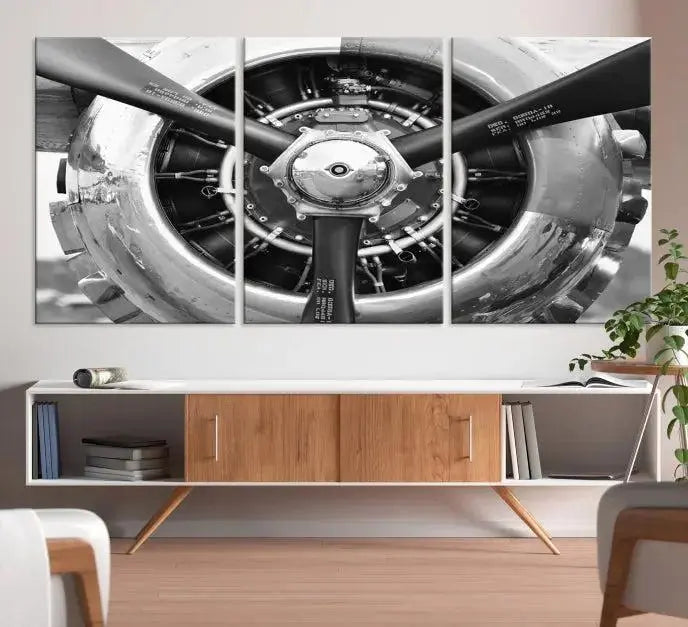 The Vintage Airplane Wall Art Canvas Print features a black and white image of an aircraft engine propeller elegantly divided into three panels.