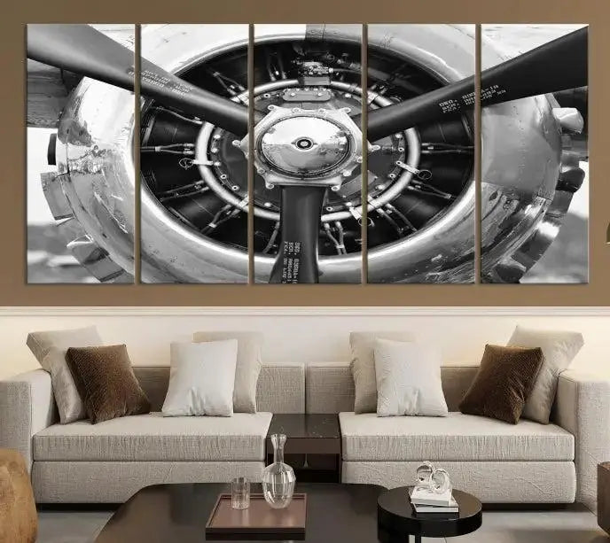 The Vintage Airplane Wall Art Canvas Print features a black and white image of an aircraft engine propeller elegantly divided into three panels.