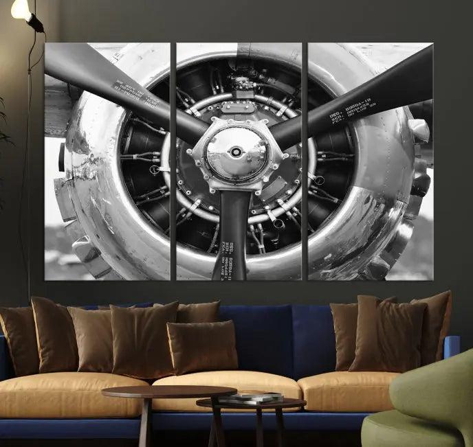 The Vintage Airplane Wall Art Canvas Print features a black and white image of an aircraft engine propeller elegantly divided into three panels.