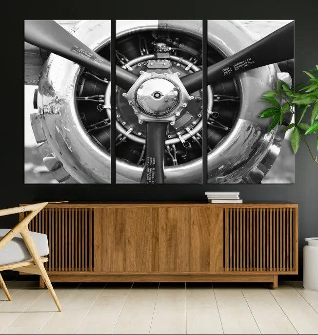 The Vintage Airplane Wall Art Canvas Print features a black and white image of an aircraft engine propeller elegantly divided into three panels.