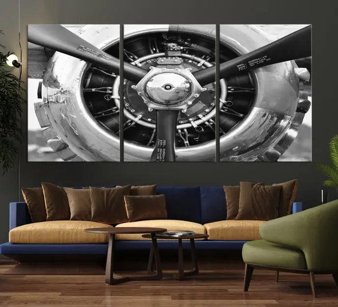 The Vintage Airplane Wall Art Canvas Print features a black and white image of an aircraft engine propeller elegantly divided into three panels.