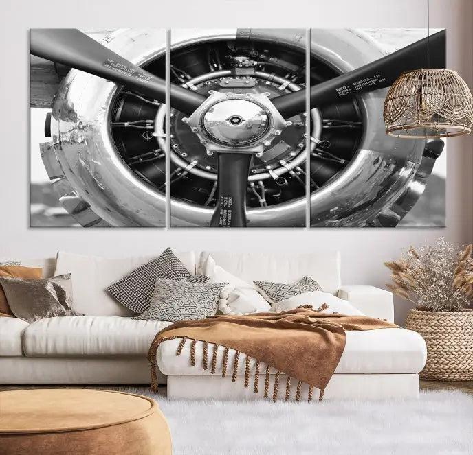 The Vintage Airplane Wall Art Canvas Print features a black and white image of an aircraft engine propeller elegantly divided into three panels.