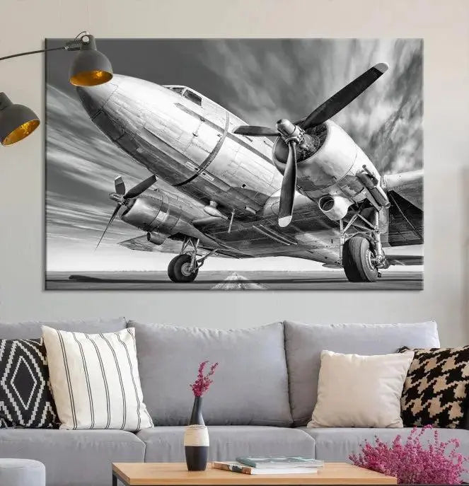 The Vintage Airplane on a Runway Canvas Print is elegantly showcased as a black and white triptych. Each panel is crafted on museum-quality canvases with a UV-protective coating for lasting beauty and durability. This timeless artwork comes with the convenience of free shipping.