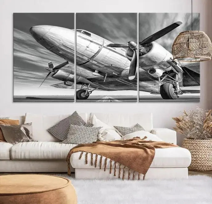 The Vintage Airplane on a Runway Canvas Print is elegantly showcased as a black and white triptych. Each panel is crafted on museum-quality canvases with a UV-protective coating for lasting beauty and durability. This timeless artwork comes with the convenience of free shipping.