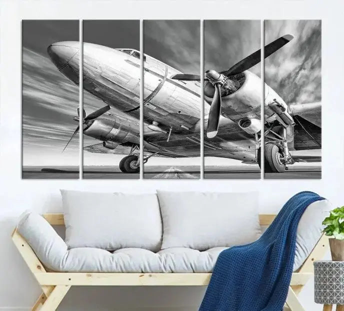 The Vintage Airplane on a Runway Canvas Print is elegantly showcased as a black and white triptych. Each panel is crafted on museum-quality canvases with a UV-protective coating for lasting beauty and durability. This timeless artwork comes with the convenience of free shipping.