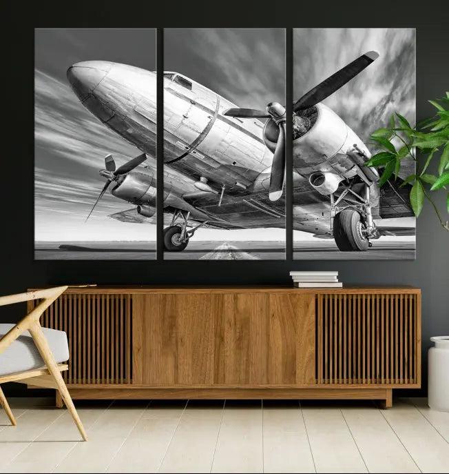 The Vintage Airplane on a Runway Canvas Print is elegantly showcased as a black and white triptych. Each panel is crafted on museum-quality canvases with a UV-protective coating for lasting beauty and durability. This timeless artwork comes with the convenience of free shipping.