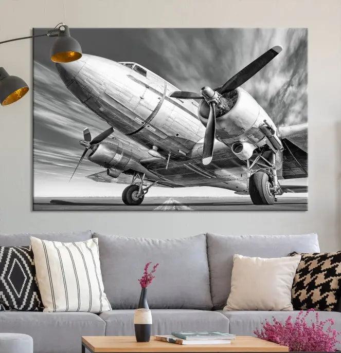 The Vintage Airplane on a Runway Canvas Print is elegantly showcased as a black and white triptych. Each panel is crafted on museum-quality canvases with a UV-protective coating for lasting beauty and durability. This timeless artwork comes with the convenience of free shipping.