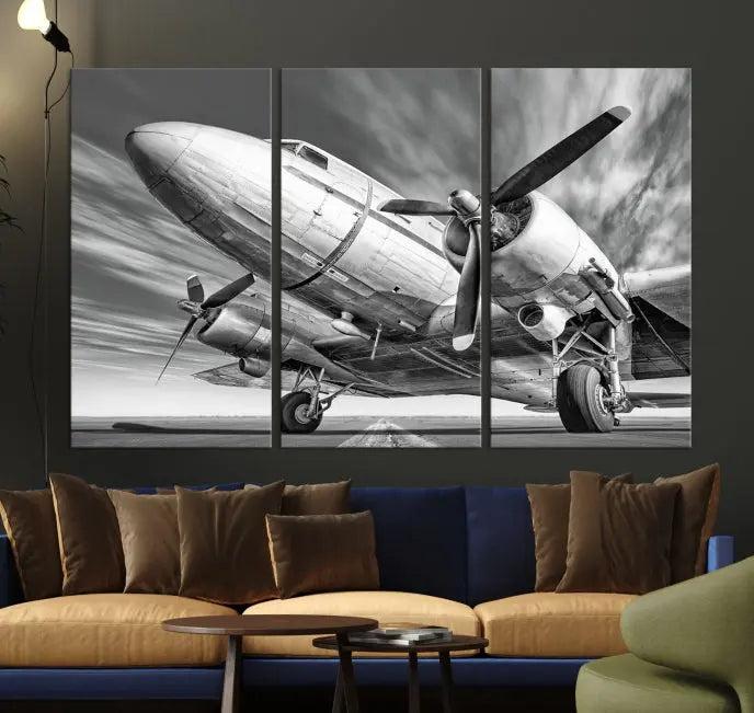 The Vintage Airplane on a Runway Canvas Print is elegantly showcased as a black and white triptych. Each panel is crafted on museum-quality canvases with a UV-protective coating for lasting beauty and durability. This timeless artwork comes with the convenience of free shipping.