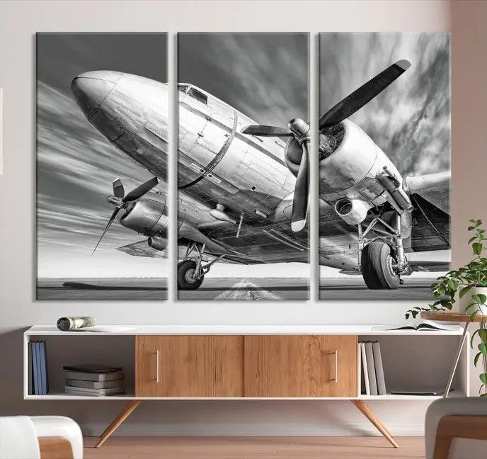 The Vintage Airplane on a Runway Canvas Print is elegantly showcased as a black and white triptych. Each panel is crafted on museum-quality canvases with a UV-protective coating for lasting beauty and durability. This timeless artwork comes with the convenience of free shipping.