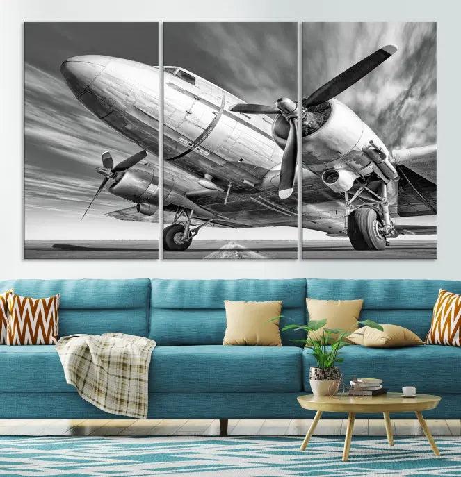 The Vintage Airplane on a Runway Canvas Print is elegantly showcased as a black and white triptych. Each panel is crafted on museum-quality canvases with a UV-protective coating for lasting beauty and durability. This timeless artwork comes with the convenience of free shipping.