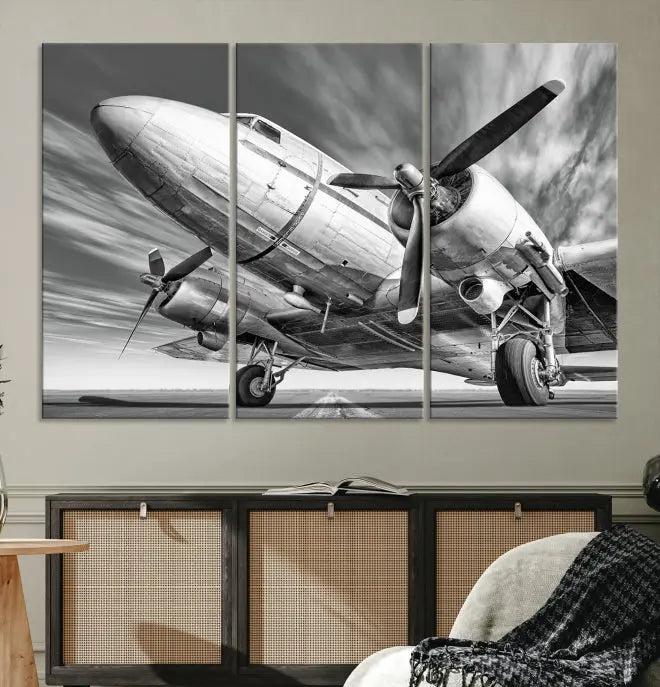 The Vintage Airplane on a Runway Canvas Print is elegantly showcased as a black and white triptych. Each panel is crafted on museum-quality canvases with a UV-protective coating for lasting beauty and durability. This timeless artwork comes with the convenience of free shipping.