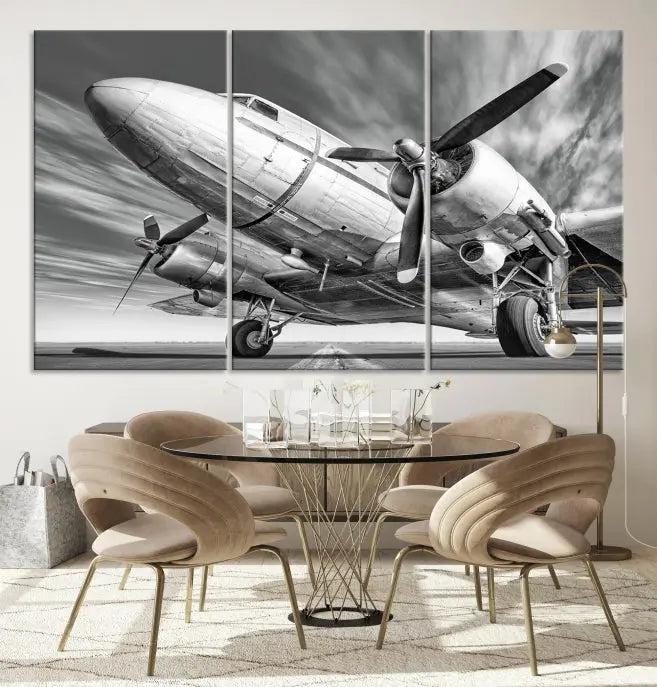 The Vintage Airplane on a Runway Canvas Print is elegantly showcased as a black and white triptych. Each panel is crafted on museum-quality canvases with a UV-protective coating for lasting beauty and durability. This timeless artwork comes with the convenience of free shipping.