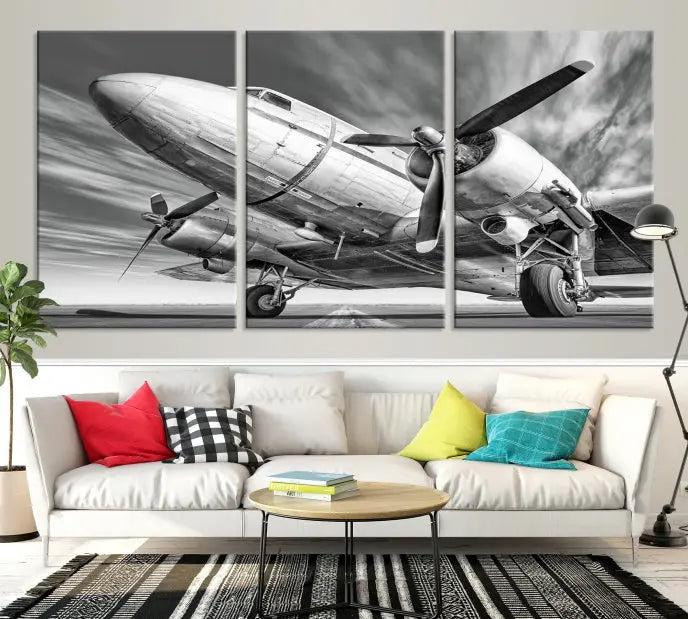 The Vintage Airplane on a Runway Canvas Print is elegantly showcased as a black and white triptych. Each panel is crafted on museum-quality canvases with a UV-protective coating for lasting beauty and durability. This timeless artwork comes with the convenience of free shipping.