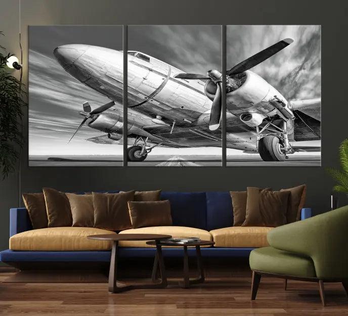 The Vintage Airplane on a Runway Canvas Print is elegantly showcased as a black and white triptych. Each panel is crafted on museum-quality canvases with a UV-protective coating for lasting beauty and durability. This timeless artwork comes with the convenience of free shipping.