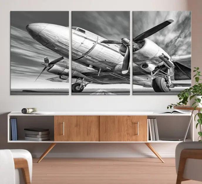 The Vintage Airplane on a Runway Canvas Print is elegantly showcased as a black and white triptych. Each panel is crafted on museum-quality canvases with a UV-protective coating for lasting beauty and durability. This timeless artwork comes with the convenience of free shipping.