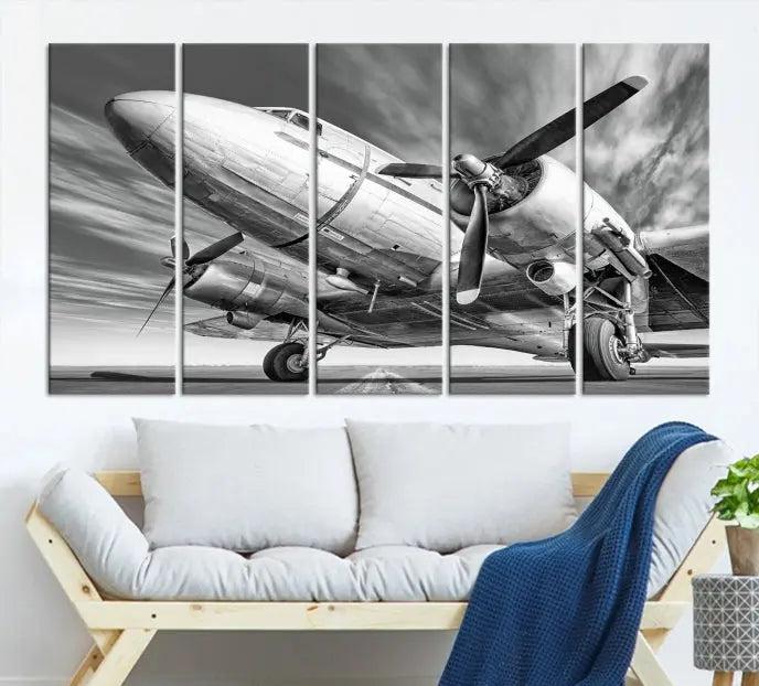 The Vintage Airplane on a Runway Canvas Print is elegantly showcased as a black and white triptych. Each panel is crafted on museum-quality canvases with a UV-protective coating for lasting beauty and durability. This timeless artwork comes with the convenience of free shipping.