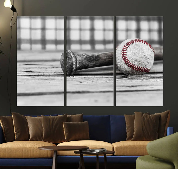 The Vintage Baseball Canvas Wall Art Print showcases a black and white photo of a baseball and bat on a wooden table, divided into three panels. Printed on museum-quality canvas with a UV-protective coating, this artwork arrives ready to hang, bringing timeless charm to any room.