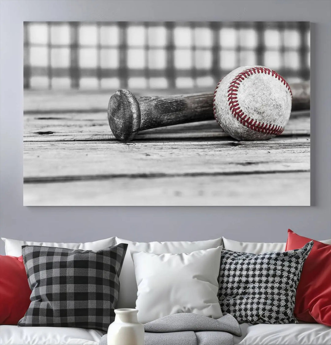 The Vintage Baseball Canvas Wall Art Print showcases a black and white photo of a baseball and bat on a wooden table, divided into three panels. Printed on museum-quality canvas with a UV-protective coating, this artwork arrives ready to hang, bringing timeless charm to any room.