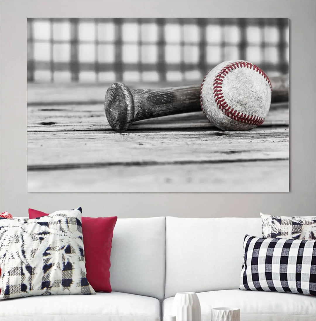 The Vintage Baseball Canvas Wall Art Print showcases a black and white photo of a baseball and bat on a wooden table, divided into three panels. Printed on museum-quality canvas with a UV-protective coating, this artwork arrives ready to hang, bringing timeless charm to any room.