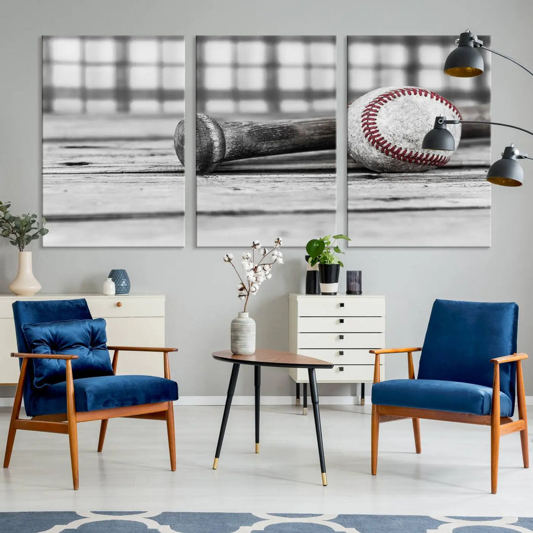 The Vintage Baseball Canvas Wall Art Print showcases a black and white photo of a baseball and bat on a wooden table, divided into three panels. Printed on museum-quality canvas with a UV-protective coating, this artwork arrives ready to hang, bringing timeless charm to any room.