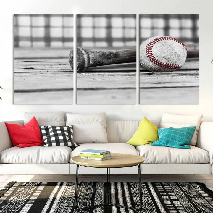 The Vintage Baseball Canvas Wall Art Print showcases a black and white photo of a baseball and bat on a wooden table, divided into three panels. Printed on museum-quality canvas with a UV-protective coating, this artwork arrives ready to hang, bringing timeless charm to any room.