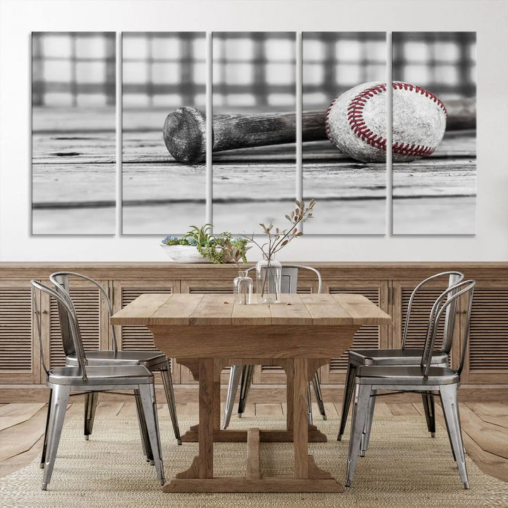 The Vintage Baseball Canvas Wall Art Print showcases a black and white photo of a baseball and bat on a wooden table, divided into three panels. Printed on museum-quality canvas with a UV-protective coating, this artwork arrives ready to hang, bringing timeless charm to any room.