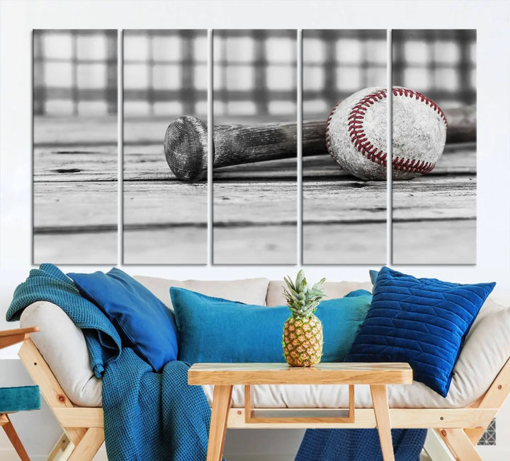 The Vintage Baseball Canvas Wall Art Print showcases a black and white photo of a baseball and bat on a wooden table, divided into three panels. Printed on museum-quality canvas with a UV-protective coating, this artwork arrives ready to hang, bringing timeless charm to any room.