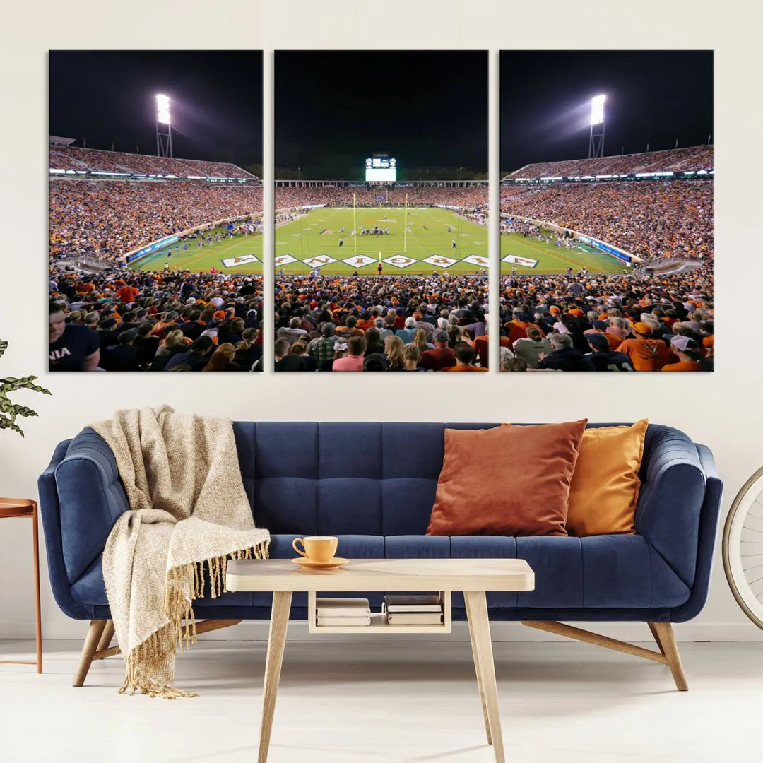 A magnificent canvas print of the Virginia Cavaliers Football Team at Charlottesville's Scott Stadium graces the wall. This striking piece of wall art offers a gallery-quality finish, enhancing the space with its dynamic presence.