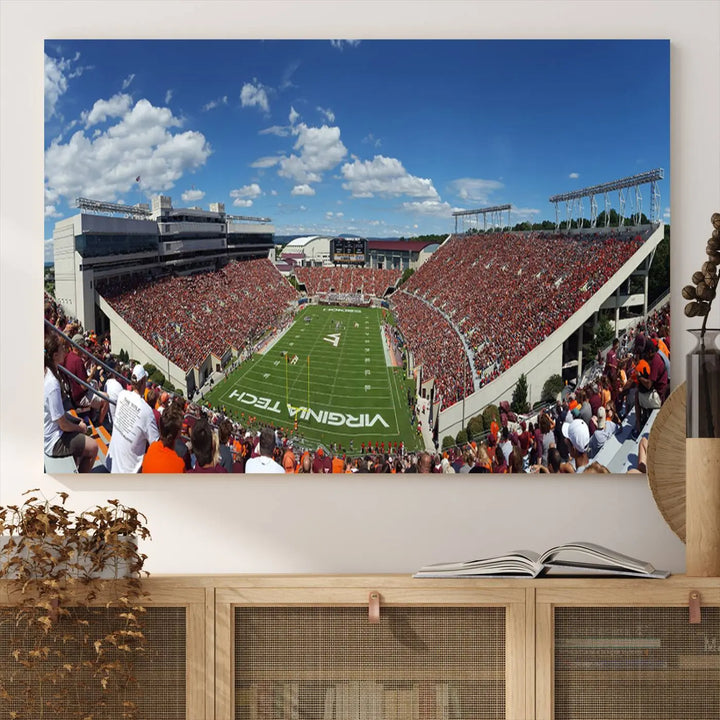 A gallery-quality triptych of the Virginia Tech Hokies Football Team, capturing the vibrant Blacksburg Lane Stadium, hangs in a well-lit, modern room. This handmade canvas artwork from the USA adds a dynamic touch to the space.