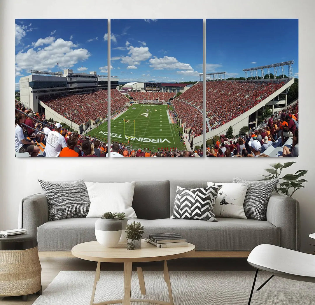 A gallery-quality triptych of the Virginia Tech Hokies Football Team, capturing the vibrant Blacksburg Lane Stadium, hangs in a well-lit, modern room. This handmade canvas artwork from the USA adds a dynamic touch to the space.