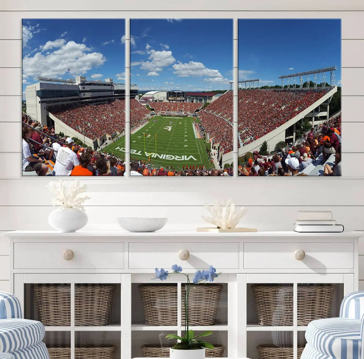 A gallery-quality triptych of the Virginia Tech Hokies Football Team, capturing the vibrant Blacksburg Lane Stadium, hangs in a well-lit, modern room. This handmade canvas artwork from the USA adds a dynamic touch to the space.