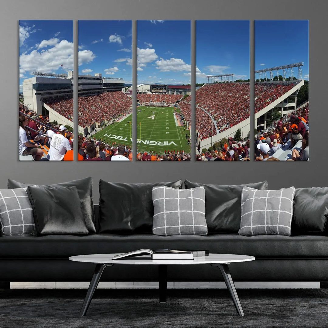 A gallery-quality triptych of the Virginia Tech Hokies Football Team, capturing the vibrant Blacksburg Lane Stadium, hangs in a well-lit, modern room. This handmade canvas artwork from the USA adds a dynamic touch to the space.