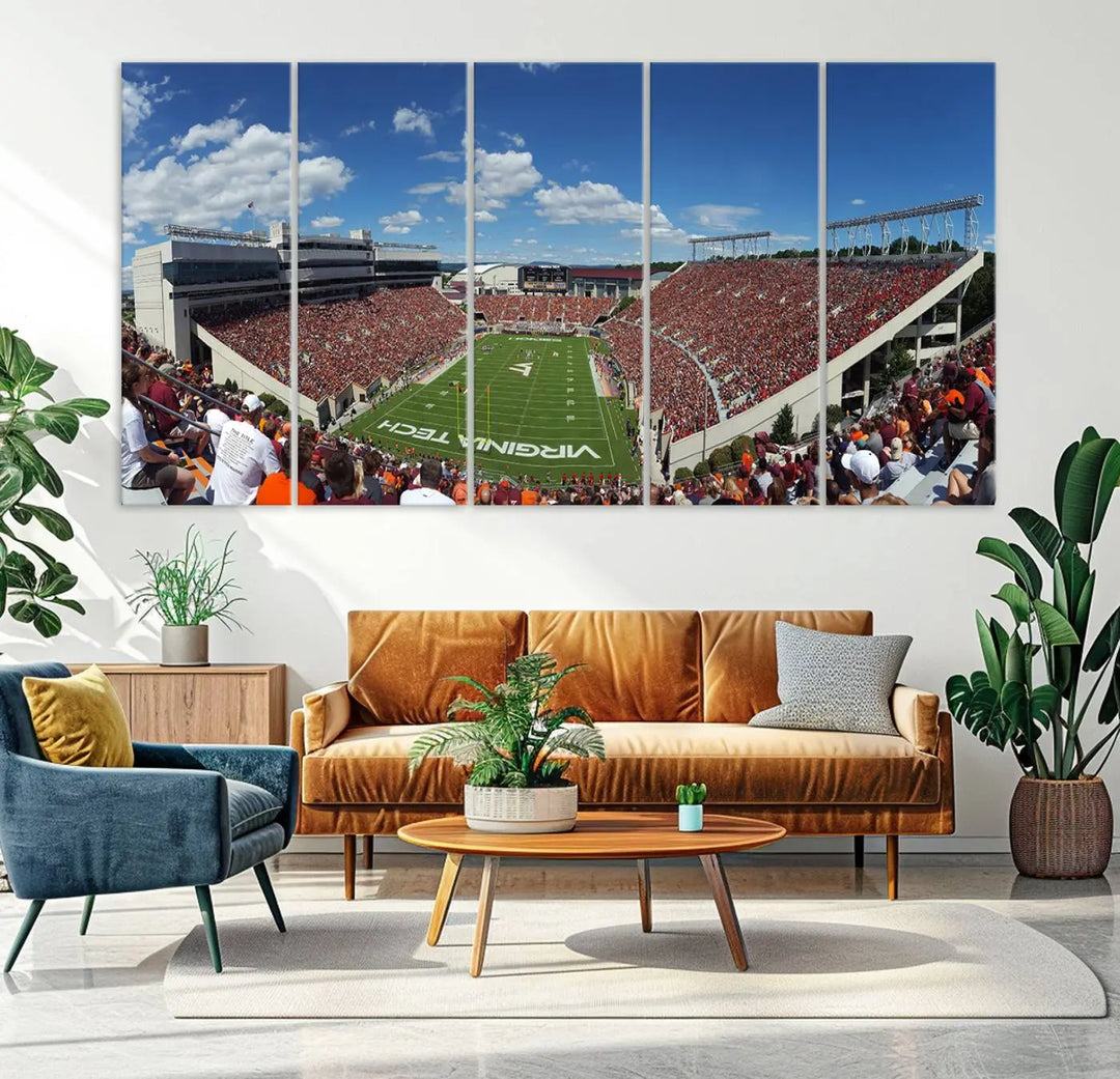 A gallery-quality triptych of the Virginia Tech Hokies Football Team, capturing the vibrant Blacksburg Lane Stadium, hangs in a well-lit, modern room. This handmade canvas artwork from the USA adds a dynamic touch to the space.