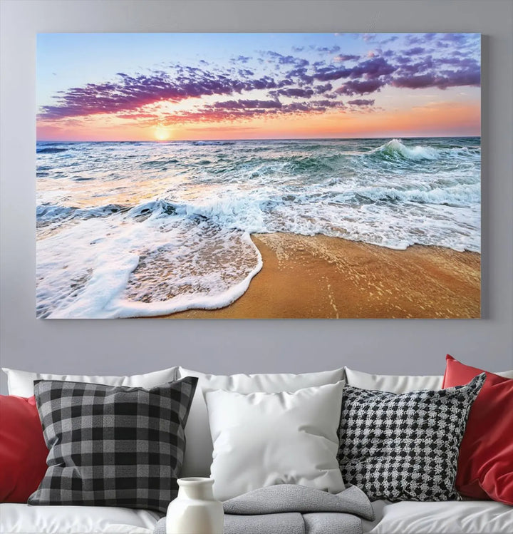 The "Vivid Sunset Ocean Waves Wall Art" hangs on the wall, capturing the serene beauty of the sea. This coastal beach canvas print triptych perfectly enhances living rooms and relaxation spaces.