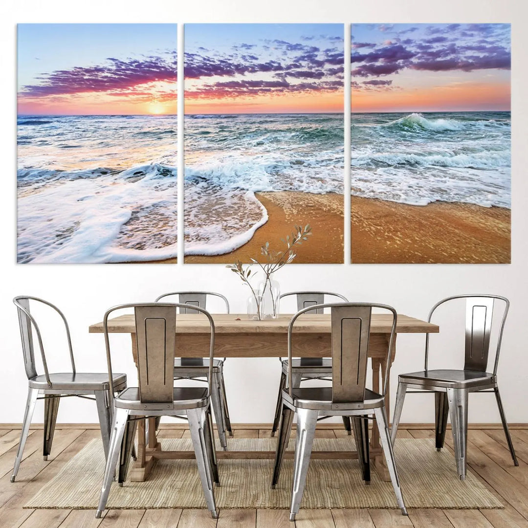 The "Vivid Sunset Ocean Waves Wall Art" hangs on the wall, capturing the serene beauty of the sea. This coastal beach canvas print triptych perfectly enhances living rooms and relaxation spaces.