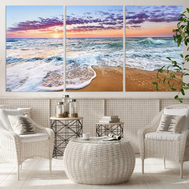 The "Vivid Sunset Ocean Waves Wall Art" hangs on the wall, capturing the serene beauty of the sea. This coastal beach canvas print triptych perfectly enhances living rooms and relaxation spaces.