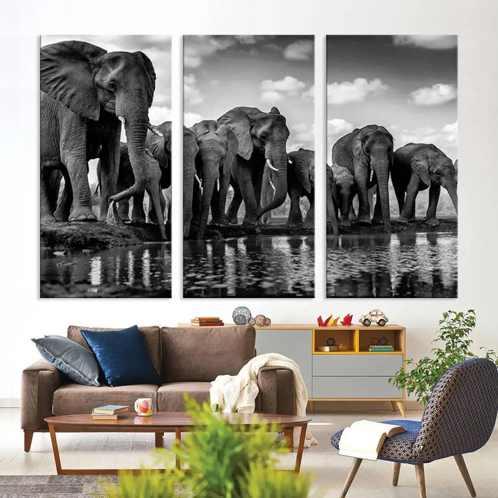 A stunning "Wall Art Animal Canvas Print" featuring a black and white photo of a herd of elephants drinking water is elegantly displayed, gallery wrapped on museum-quality canvas.