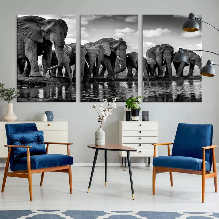 A stunning "Wall Art Animal Canvas Print" featuring a black and white photo of a herd of elephants drinking water is elegantly displayed, gallery wrapped on museum-quality canvas.