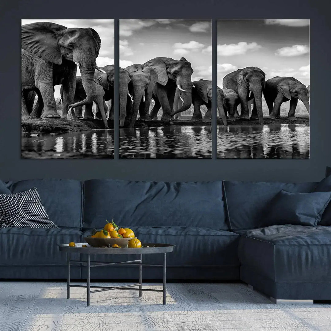 A stunning "Wall Art Animal Canvas Print" featuring a black and white photo of a herd of elephants drinking water is elegantly displayed, gallery wrapped on museum-quality canvas.